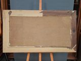 an old wooden easel with a painting on it in front of a blue wall