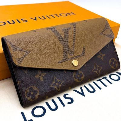 the louis vuitton wallet is sitting on top of a box