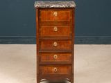 an antique wooden chest of drawers with marble top