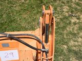 a small orange machine that is sitting in the grass