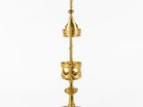 an image of a brass candle holder with a bell on it