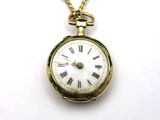 a gold clock with roman numerals on a chain