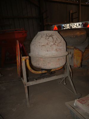 a cement mixer sitting in the middle of a room