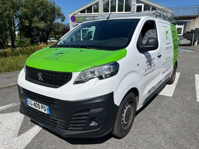 the green and white van is parked on the side of the road