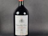 a bottle of wine sitting on top of a table next to a bottle of wine