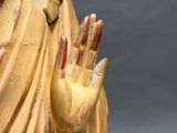 a gold statue of a person with his hands in the air