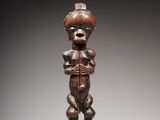 une image d'une statue en bois représentant un homme tenant un bébé