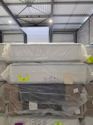 several boxes of mattresses stacked on top of each other in a warehouse