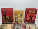 five children ' s books are lined up on a white surface