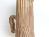 a brown pitcher that is sitting on a white surface
