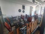 tables and chairs in a restaurant with menus on the wall