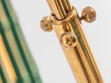 a close up of a brass and green umbrella on a white background