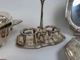 a silver plate with a silver spoon and a silver plate with a silver spoon and a silver plate with a silver spoon and a silver plate with a silver