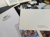 a pile of postcards and other items on a table