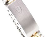 a close up of a watch on a white surface