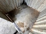 a dirty bathroom with a dirty floor and dirty walls