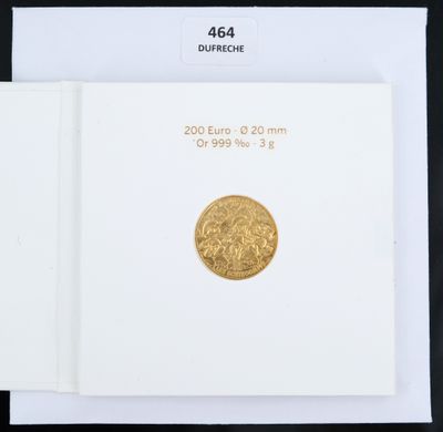 a close up of a book with a gold coin on top of it