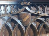 a close up of a wooden bench in a church