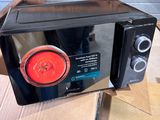 a microwave that is sitting on top of a cardboard box