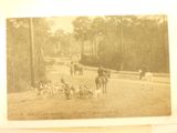 an old photo of a group of people riding horses and dogs