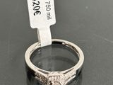 a close up of a diamond ring on a table with a price tag