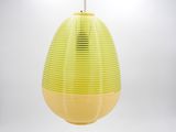 a yellow lamp that is hanging from the ceiling