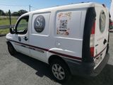 a white van with stickers on it parked in a parking lot