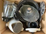 a cardboard box filled with various kitchen appliances and appliances