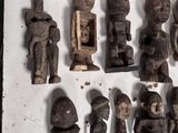 a lot of wooden figurines that are on the wall