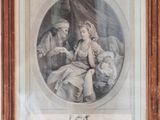 a framed picture of a family with a child and a dog