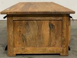 a wooden table with a drawer on it in the middle of a room