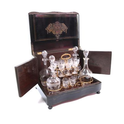 a box that has a set of glasses and a decanter in it