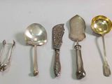 five spoons and a ladle on a table