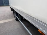a white truck parked in a parking lot next to a building