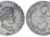 a silver coin with a woman ' s head and a crown on it
