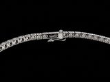 an image of a silver bracelet with diamonds on a black background