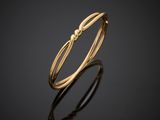 a gold ring with a knot on it