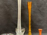 several different colored glass vases and bowls sitting on a table