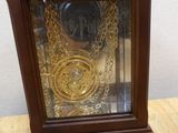 a clock that is sitting on a table with a chain around it