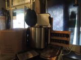 a coffee pot sitting on top of a counter next to a box