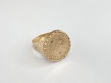 a gold ring with a roman coin on it