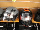 many helmets that are on a shelf in a store