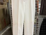 a picture of a pair of white pants hanging on a rack