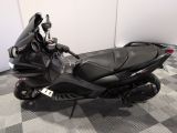a black motorcycle that is parked on a checkered floor