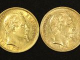 two gold sovereigns, one of which has a head of a man and the other of a woman