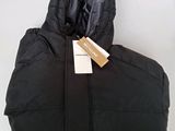 the jacket is black and has a tag on it
