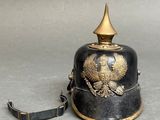 a black and gold bell with a gold eagle on it