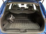the back of a blue car with the trunk open and luggage in the trunk