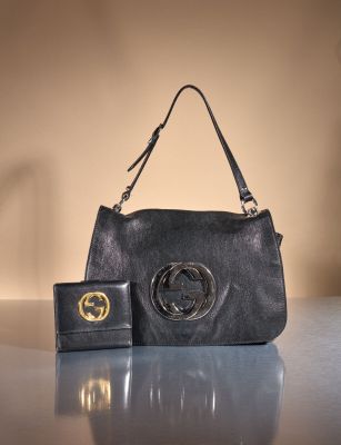 an image of a black purse and wallet on a table