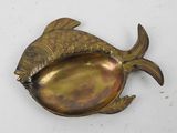 a gold fish shaped dish with a spoon in it
